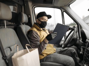 A person checking a document while driving.