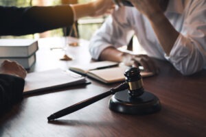A wrongful death lawyer in Napoleon consoling a client who lost a loved one with a touch to the shoulder.