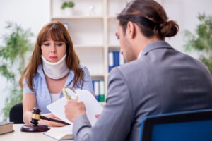 An experienced motorcycle accident lawyer in North Baltimore discussing legal options with an injured client who has their arm in a sling.