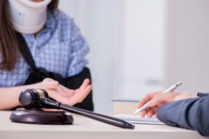 Closeup of an experienced truck accident lawyer in Defiance discussing legal options with an injured client with a neck brace and arm sling.