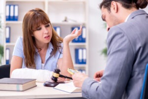 An experienced dog bite lawyer in North Baltimore discussing legal options with an injured client who has their arm bandaged.