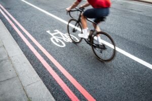 A cyclist rides along a Toledo roadway where heavy traffic and busy intersections can increase the risk of bicycle accidents.